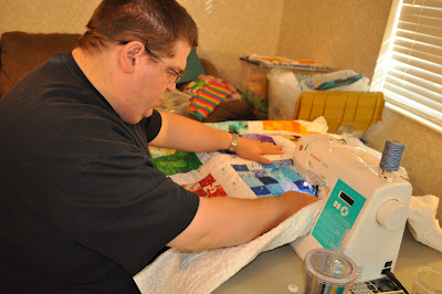 Richard sewing a quilt at home