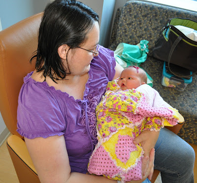 A baby wrapped in a handmade quilt